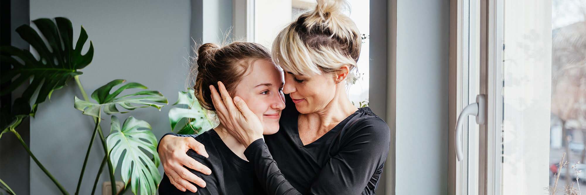 A mom gives hugs and encouragement to her teen daughter in residential treatment for anorexia.